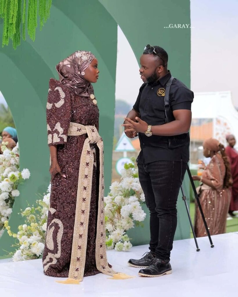 Kitandwe Brian, the creative lead planner of Kit Events Uganda, pictured with a bried on her traditional wedding. Image Source: Instagram/@kiteventsug