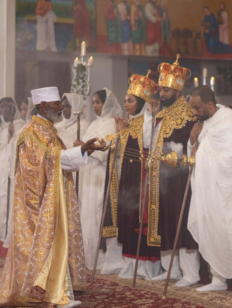 A priest seen purifying a couple at their Orthodox church wedding with incense, photographed by Getnet Teshome. Image Source: Instagram/@gettphotography